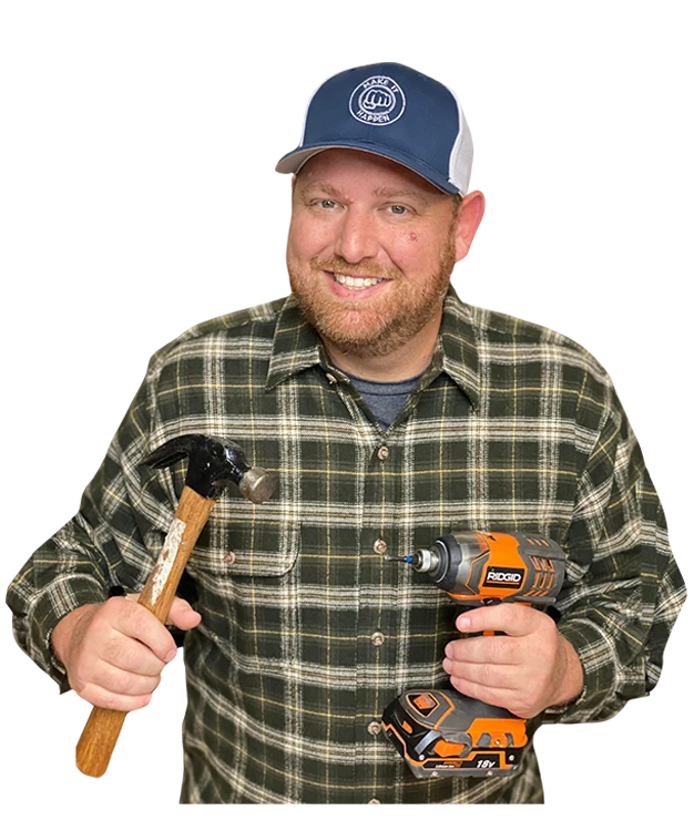 Ryan-Bio-Section-Image-8b (1) Ryan Gromfin holding a hammer and a drill